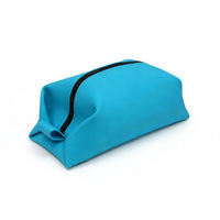Side profile of a bright blue toiletry organizer, featuring compact rectangular shape and integrated loop handle for easy carrying.