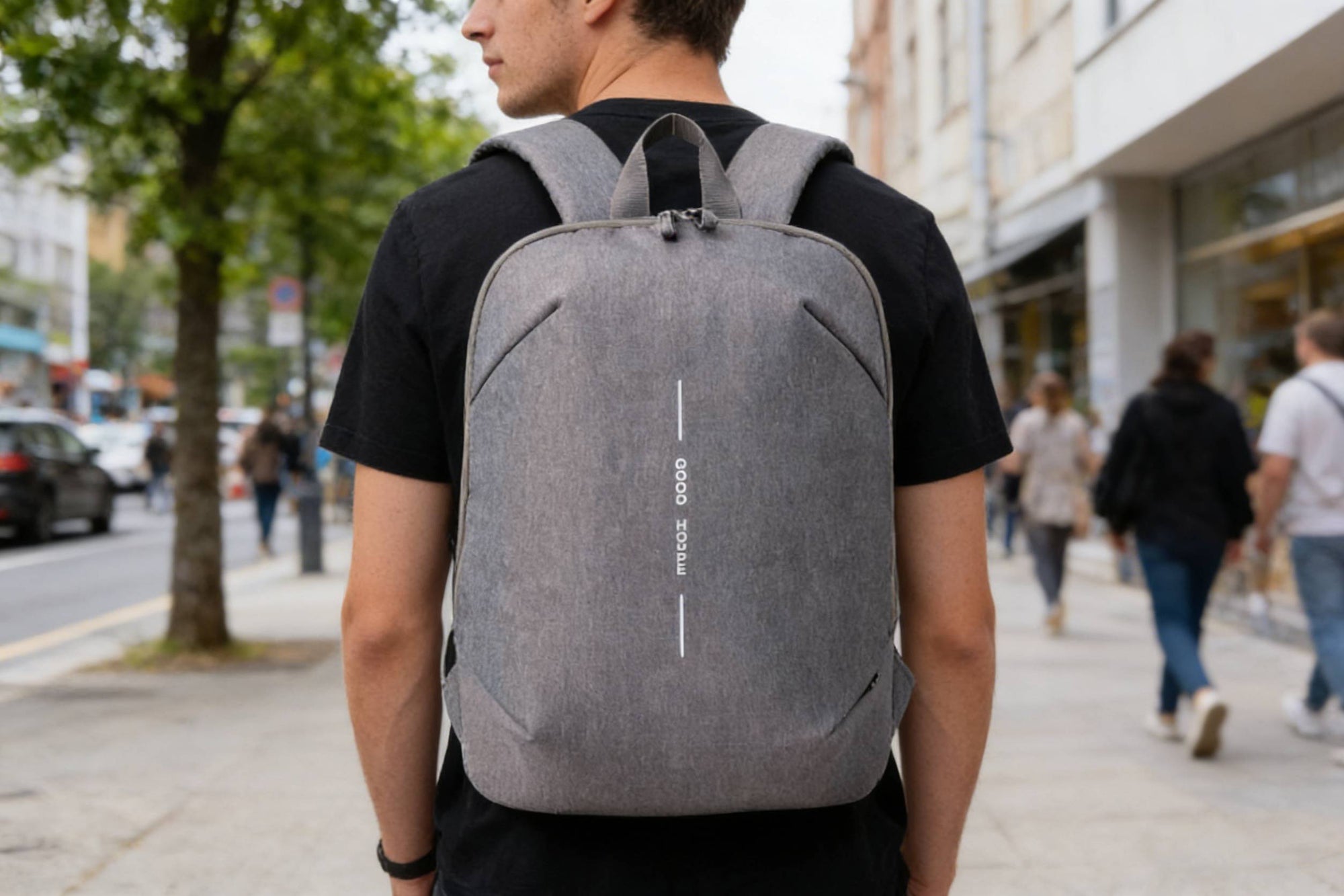 Model carrying a gray backpack