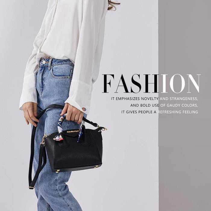 Model wearing a black pebbled leather handbag with a detachable crossbody strap, demonstrating versatile carry options and everyday fashion appeal.