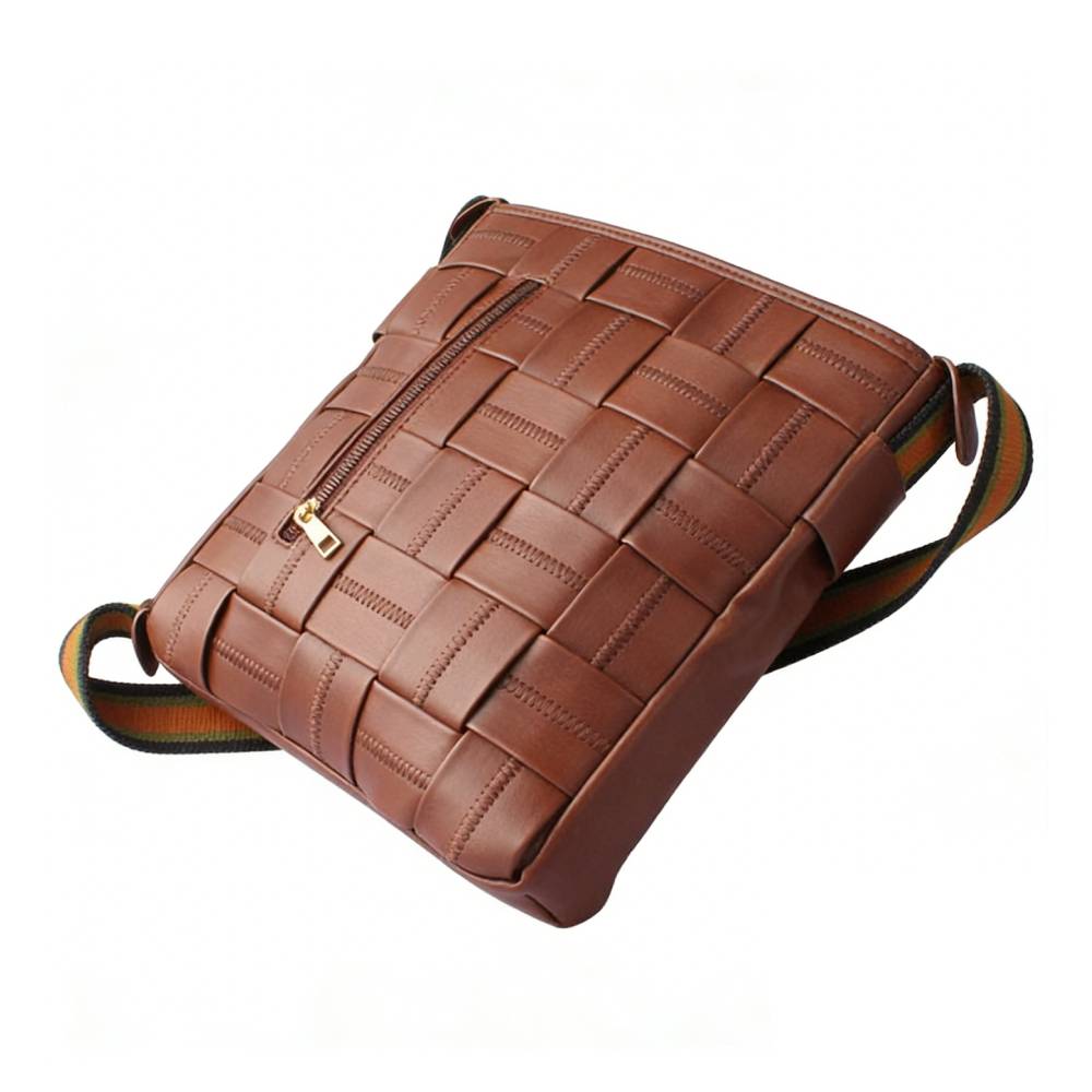 Angled side view of a brown woven leather crossbody bag, displaying the front zippered pocket and textured woven pattern.