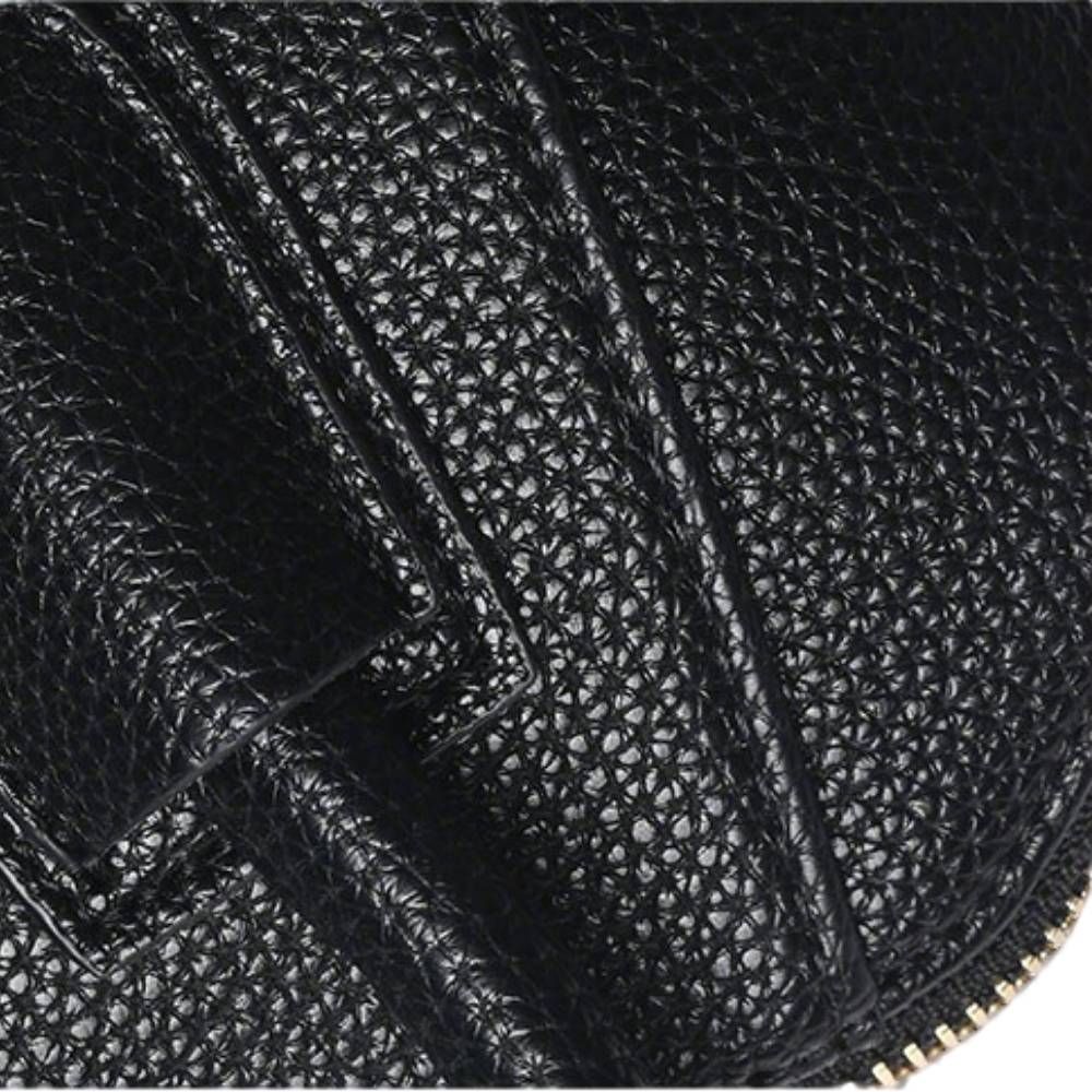 Close-up of black pebbled leather texture with precise contrast stitching, emphasizing premium material quality and durable finish.