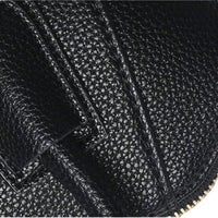 Close-up of black pebbled leather texture with precise contrast stitching, emphasizing premium material quality and durable finish.