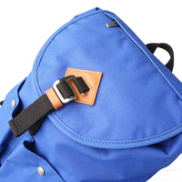 Blue Canvas Backpack - Tan Leather Patch & Buckle Hardware Detail View