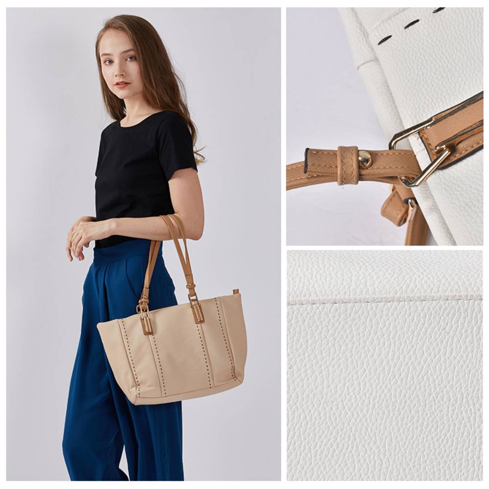 Spacious white/beige pebbled leather tote bag with brown leather handles, contrast stitching, and front zipper pocket, durable casual shoulder bag for wholesale and everyday use.
