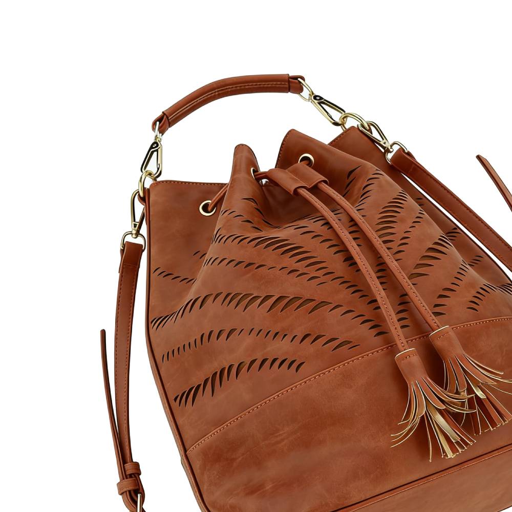 Close-up of gold metal hardware attaching top handle and crossbody strap, emphasizing sturdy and luxurious construction.