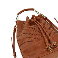 Close-up of gold metal hardware attaching top handle and crossbody strap, emphasizing sturdy and luxurious construction.