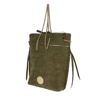 Side view of olive green suede tote bag with braided side tassels and metallic trim, showing spacious structured shape.