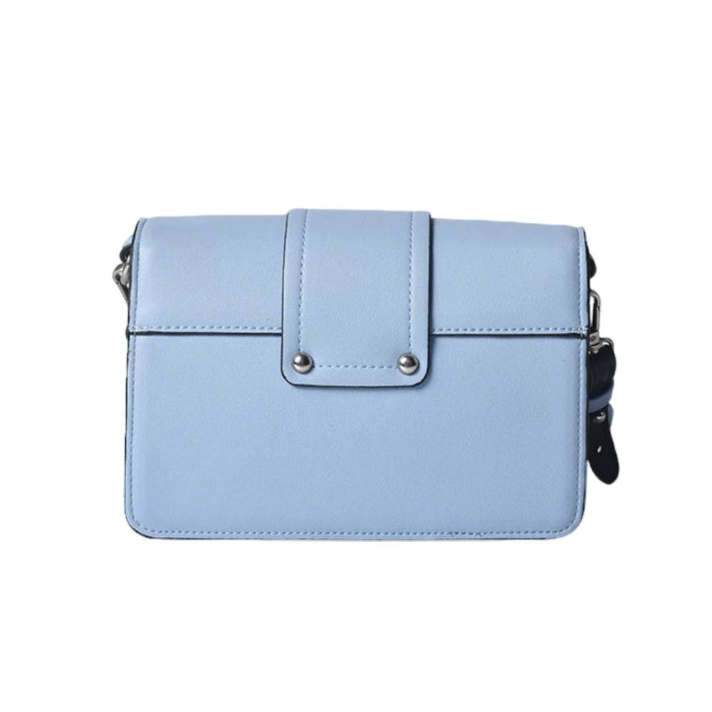Side view of light blue structured leather bag with black edge trim, showing compact shape and durable construction.