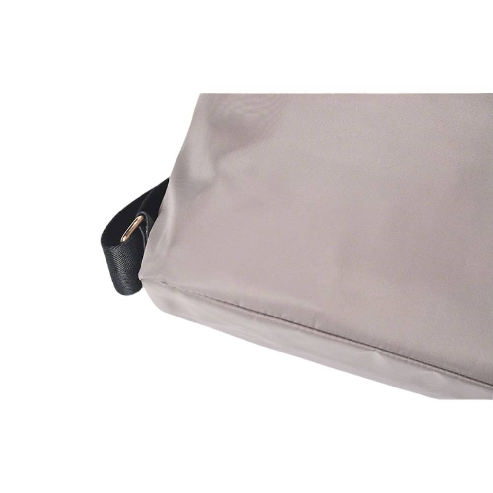 Close-up of gray nylon bag fabric and stitching, showing water-resistant material and precise craftsmanship.
