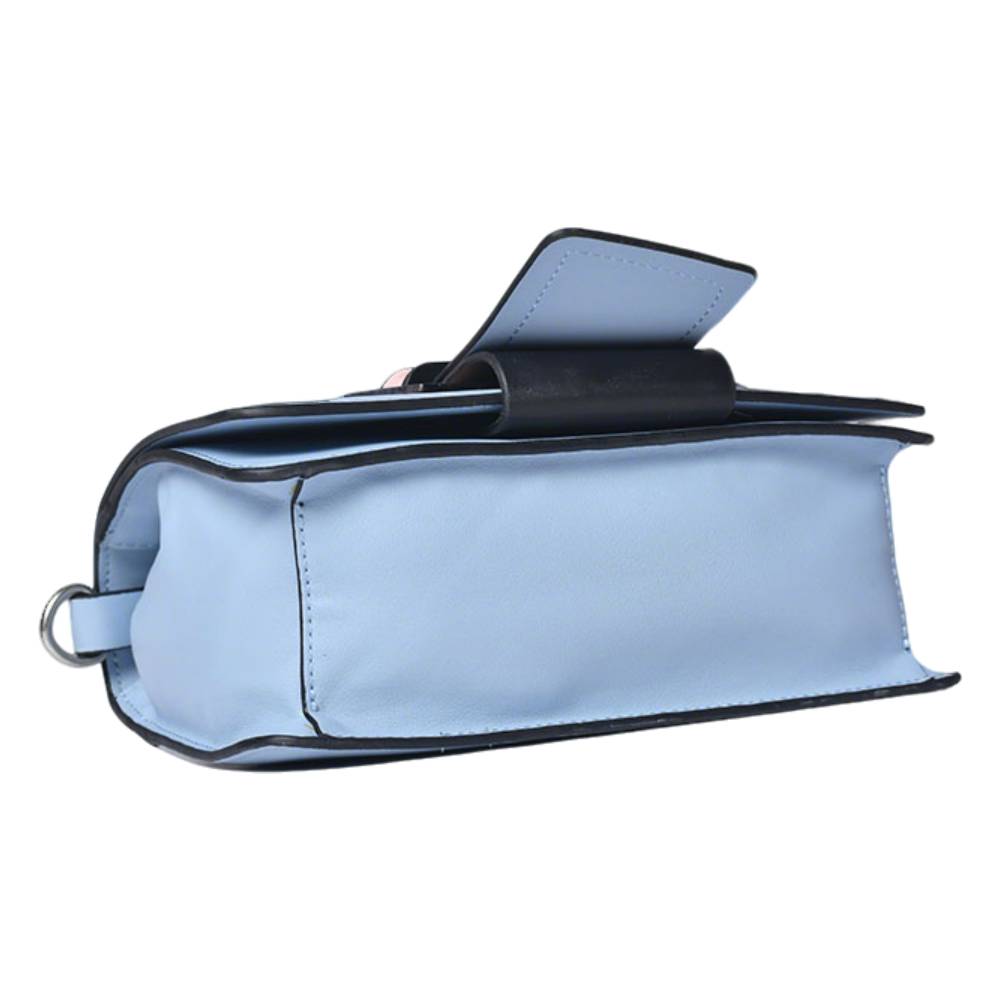 Close-up of pink geometric buckle on light blue leather bag, showing precise stitching and smooth leather texture.