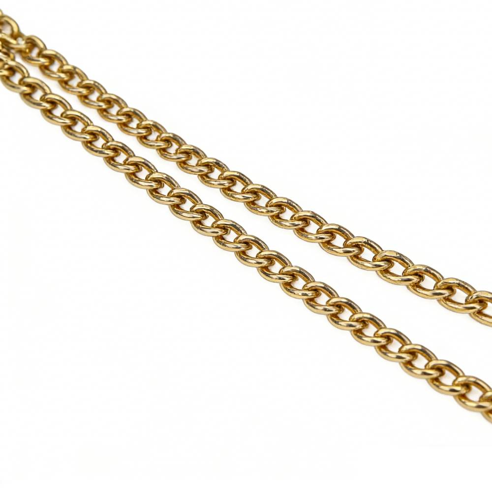 Close-up of double gold curb chain straps for suede tote bag, showcasing sturdy and luxurious hardware.