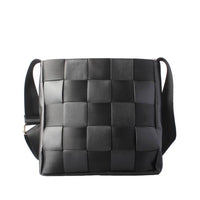 Front view of a black smooth leather crossbody bag with a top zippered pocket and gold hardware, offering a sleek and professional aesthetic.