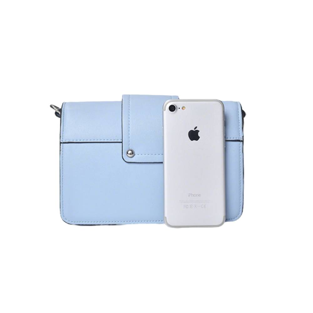 Light blue small shoulder bag next to an iPhone, showing compact size that fits a smartphone, perfect for on-the-go use.
