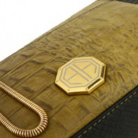 Close-up of gold snake chain strap attachment, showcasing sturdy and luxurious hardware design.