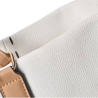 Close-up of white pebbled leather texture and contrast stitching on tote bag, highlighting premium material.