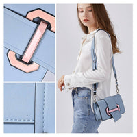 Light blue structured leather crossbody bag with pink geometric buckle, adjustable strap, compact size, durable casual shoulder bag for wholesale and everyday fashion.