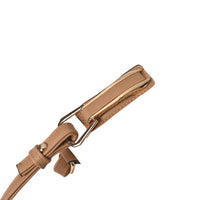 Close-up of brown leather handle with gold metal hardware on white tote bag, showing sturdy craftsmanship.