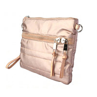 Another front angled view of a rose gold quilted crossbody bag, displaying its compact rectangular shape and versatile carry options.