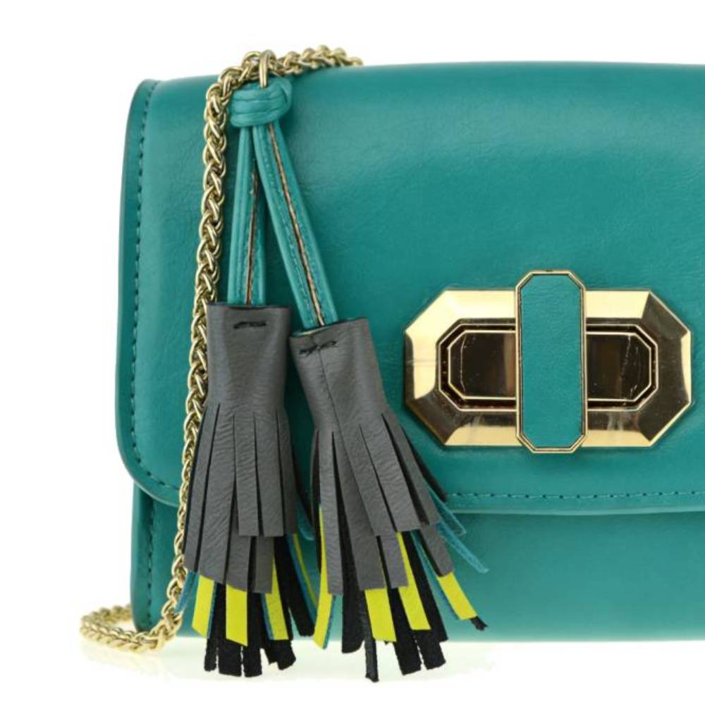 Close-up of teal green smooth leather texture with contrast stitching, highlighting premium material quality.