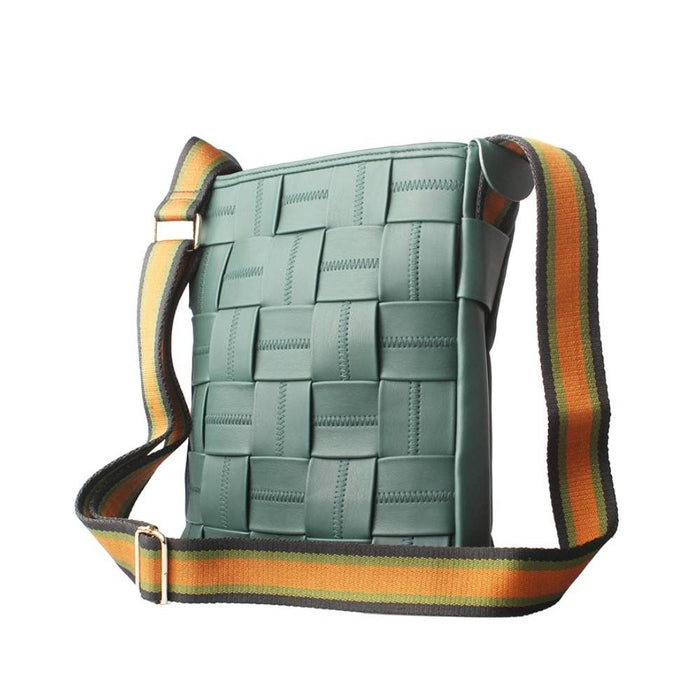 Back view of a teal woven leather crossbody bag, showing the adjustable striped shoulder strap with gold metal hardware.