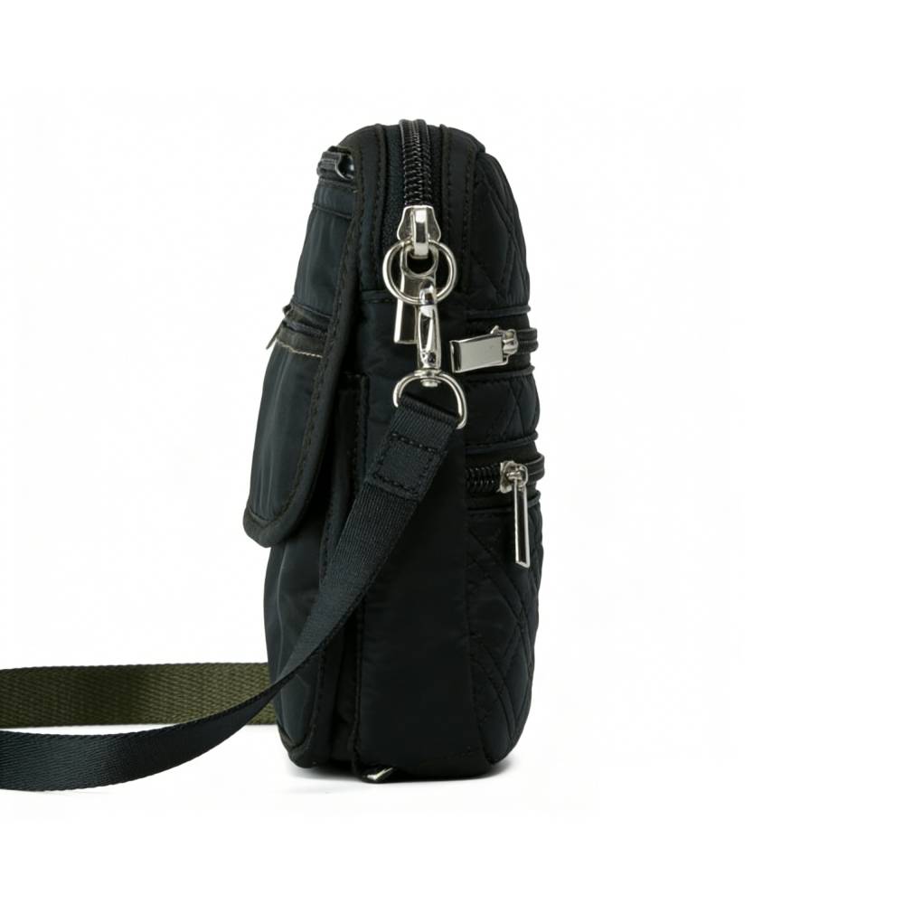 Side view of a black quilted crossbody bag, showing layered zippered pockets and adjustable strap attachment points.