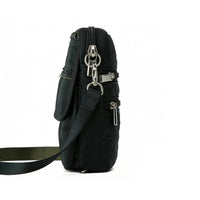 Side view of a black quilted crossbody bag, showing layered zippered pockets and adjustable strap attachment points.