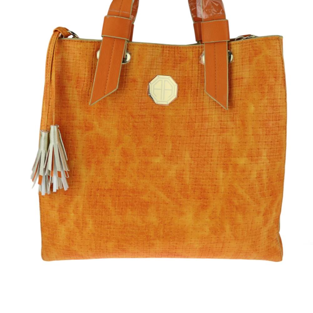 Orange structured tote bag with woven texture, leather handles, and tassel accents, versatile shoulder bag for wholesale.
