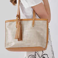 Metallic Silver Woven Tote Bag with Tassel - Worn on Shoulder View