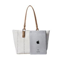 White large tote bag next to an iPad, demonstrating spacious capacity to fit a tablet, ideal for work and travel.
